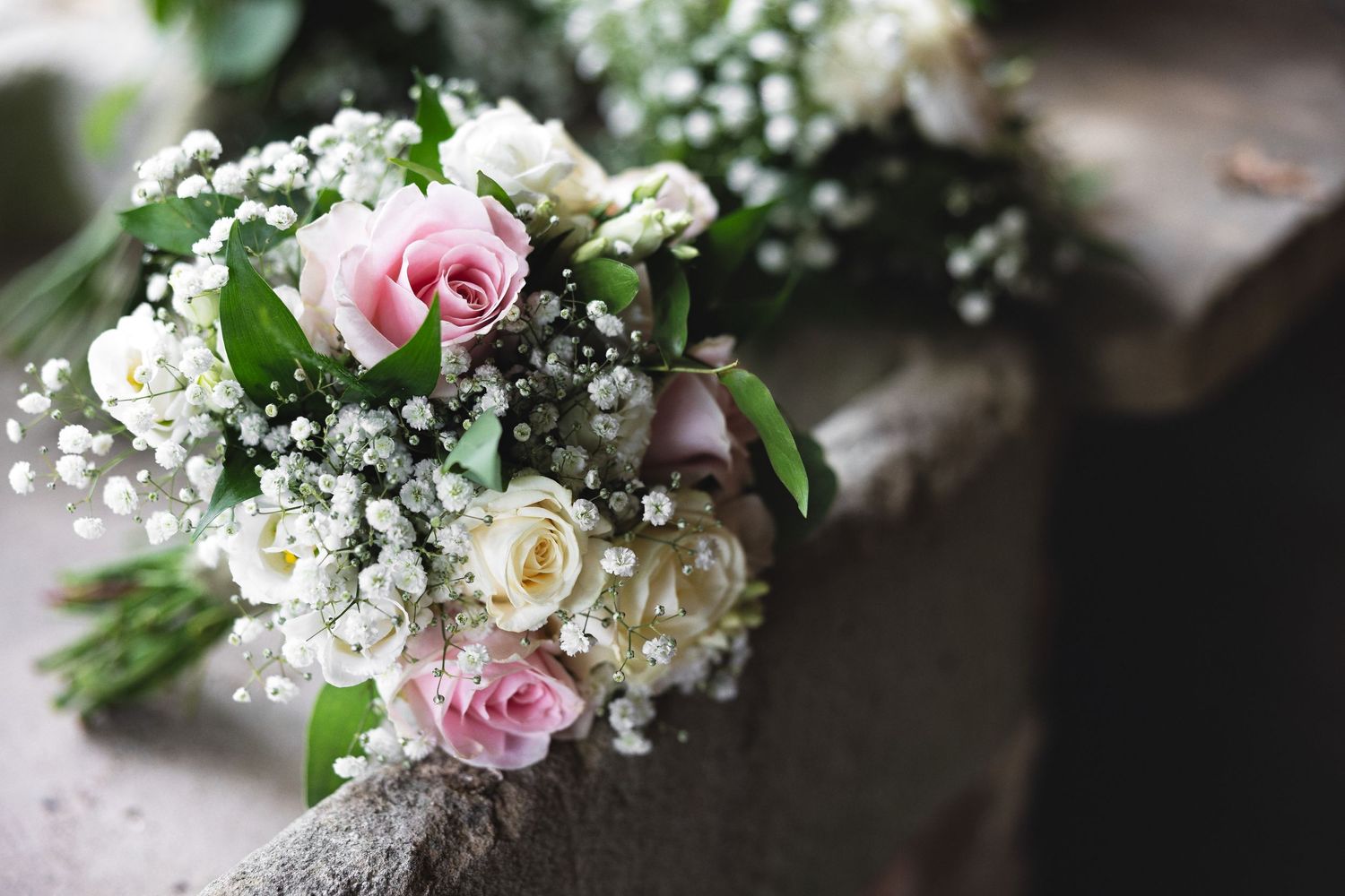 Close-up of bridal bouquet with pink roses, white flowers and baby&#039;s breath, wedding detail photography Southampton