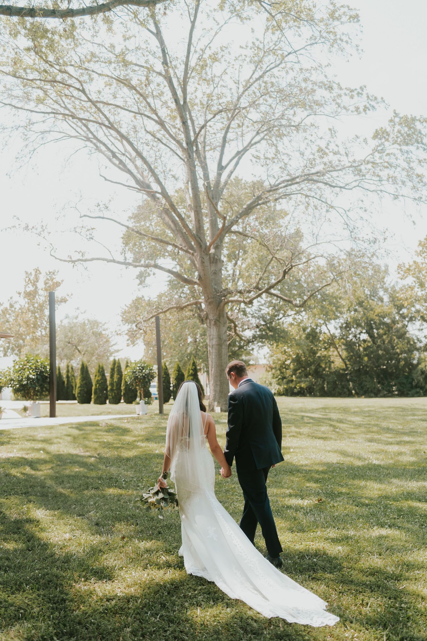 Bride and groom embracing during their wedding photoshoot photo shoot in a scenic outdoor setting.
