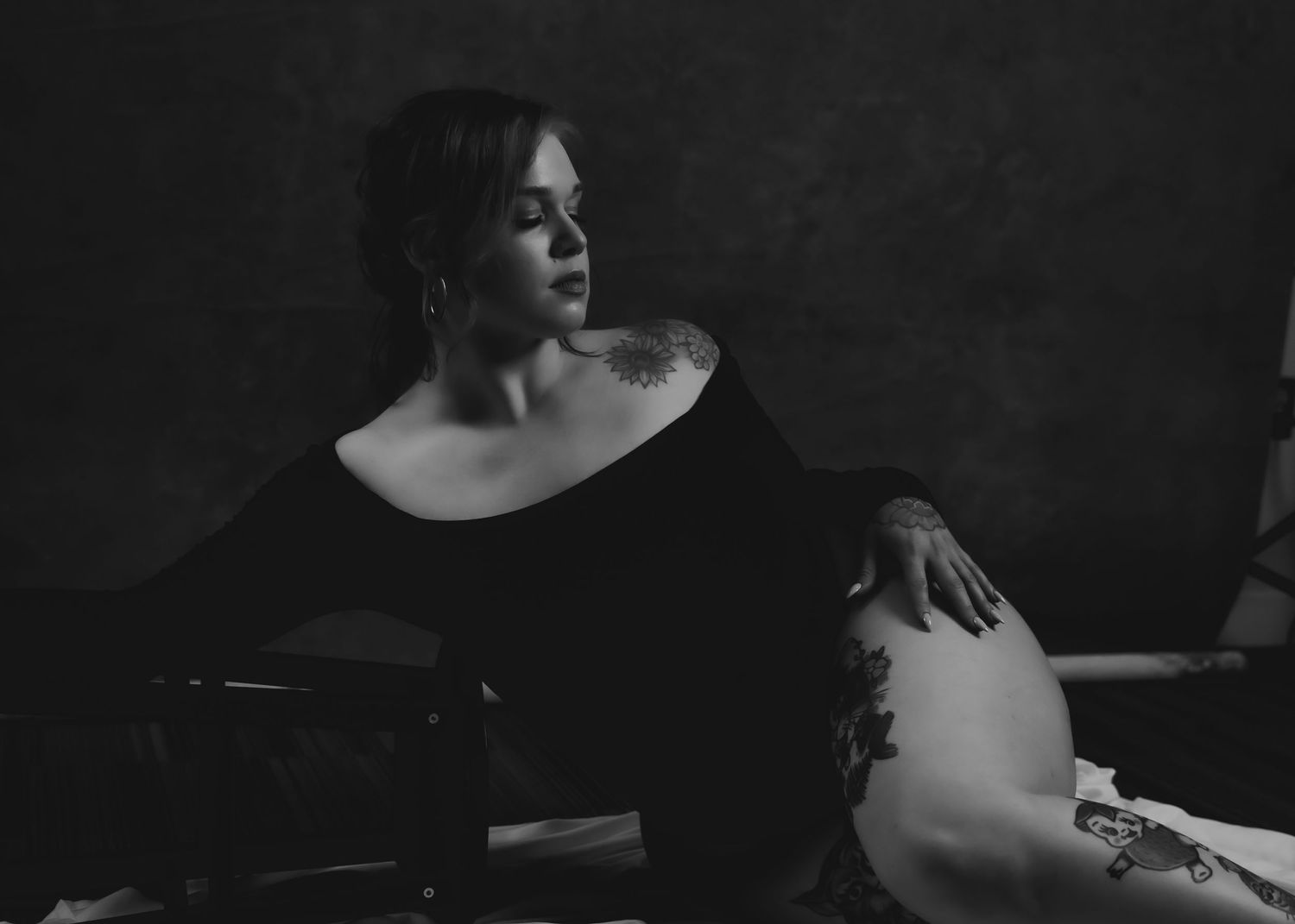 Elegant black-and-white boudoir: timeless, modest, and empowering, showcasing beauty through light, shadow, and confidence.