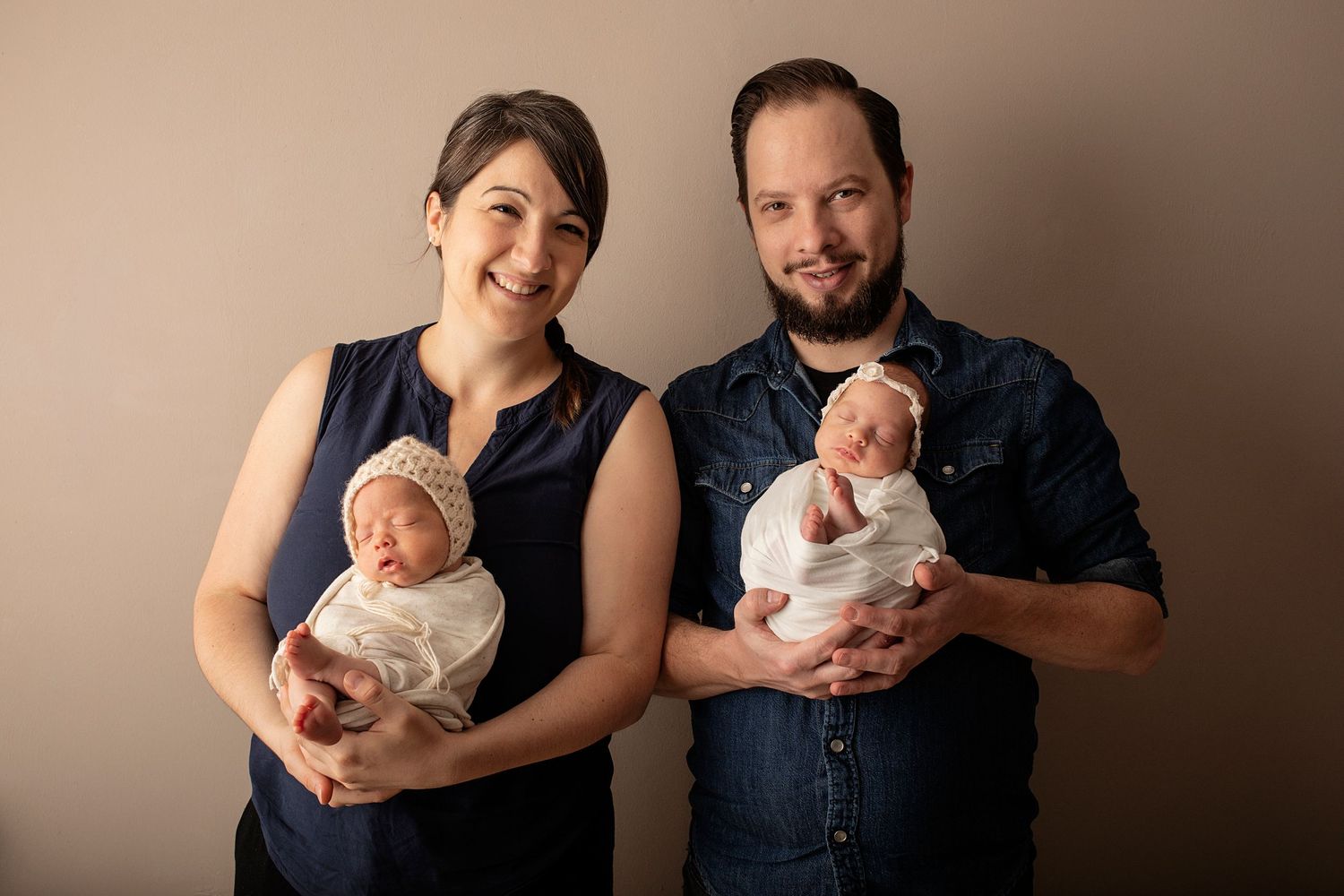 Family portrait series showing loving moments with their newborn baby.