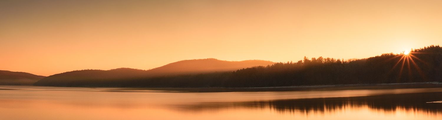 winter sunrise over reservoir