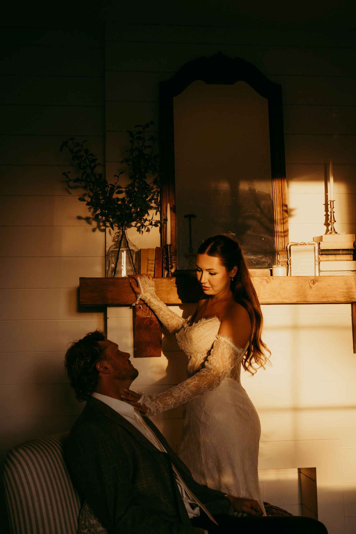 Couple shares romantic moment in a small boat on a tranquil lake surrounded by trees.