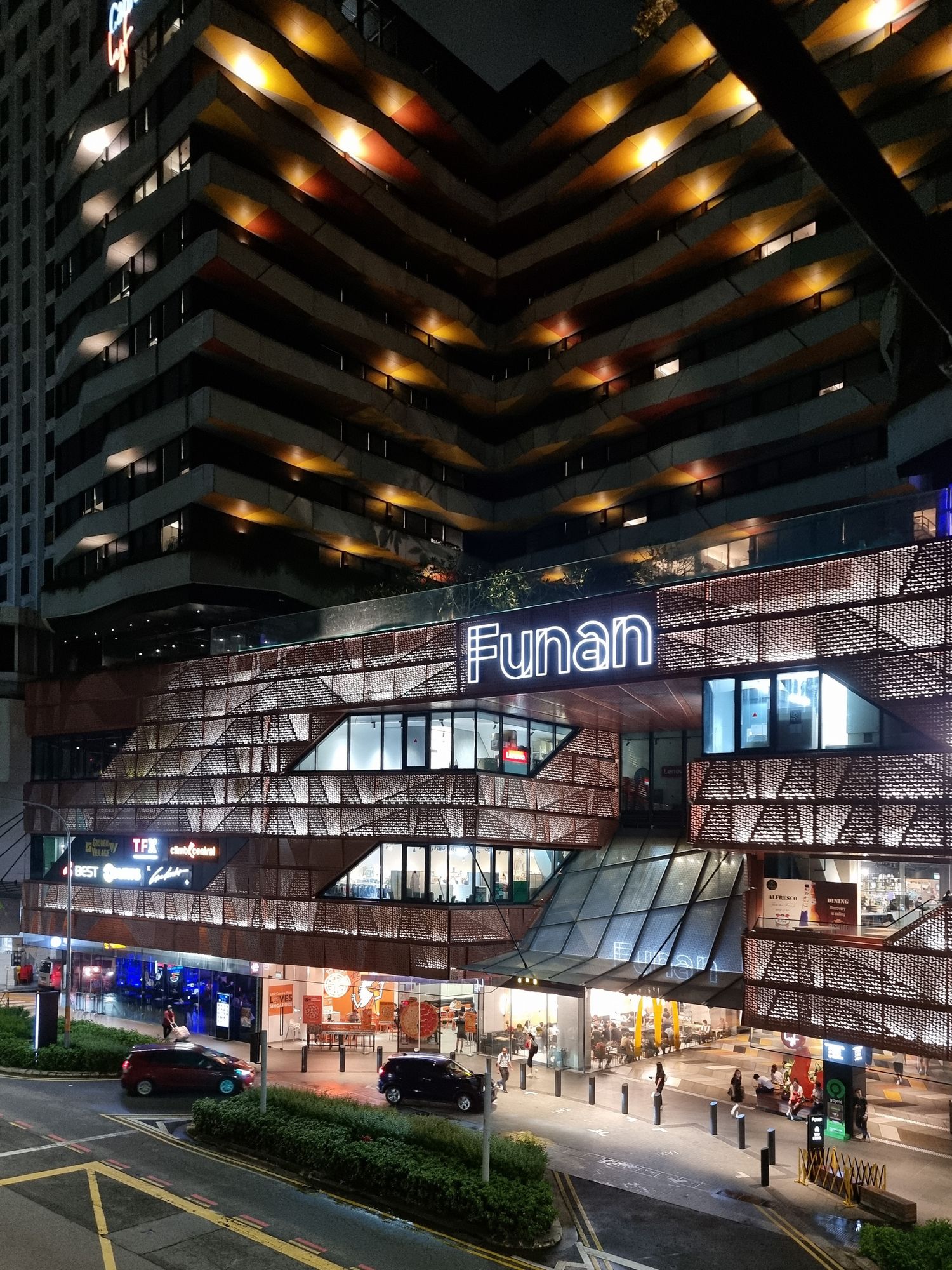 Funan mall's angular architecture illuminated at night with distinctive geometric lighting patterns.