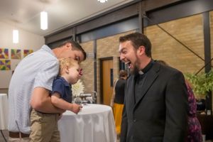 An informal conversation during a church gathering with refreshments.