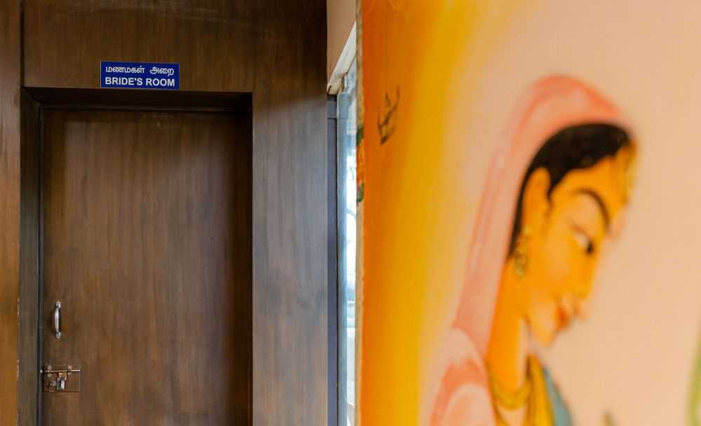 Hallway with wooden door and decorative wall painting.
