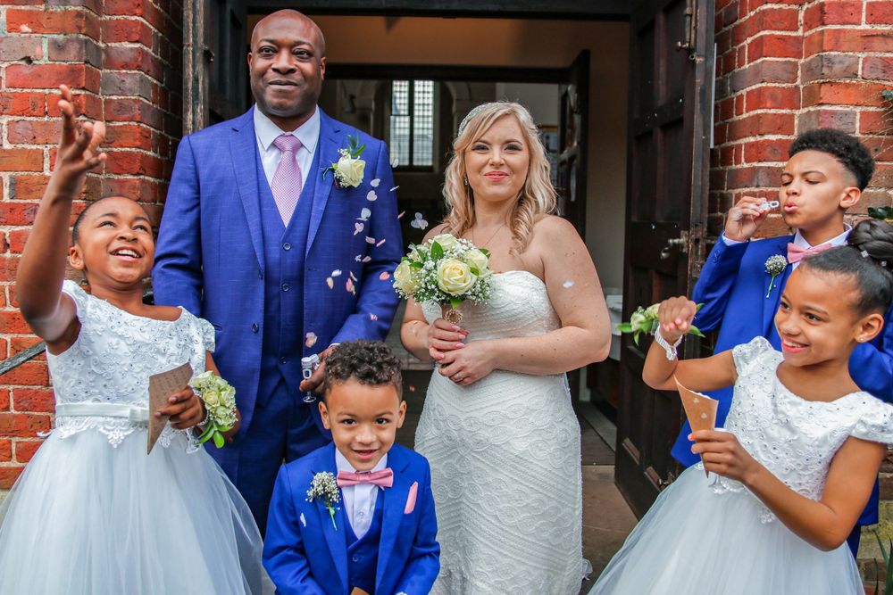 Couple on wedding day with children by H&H Photography, hhphotographyuk.com