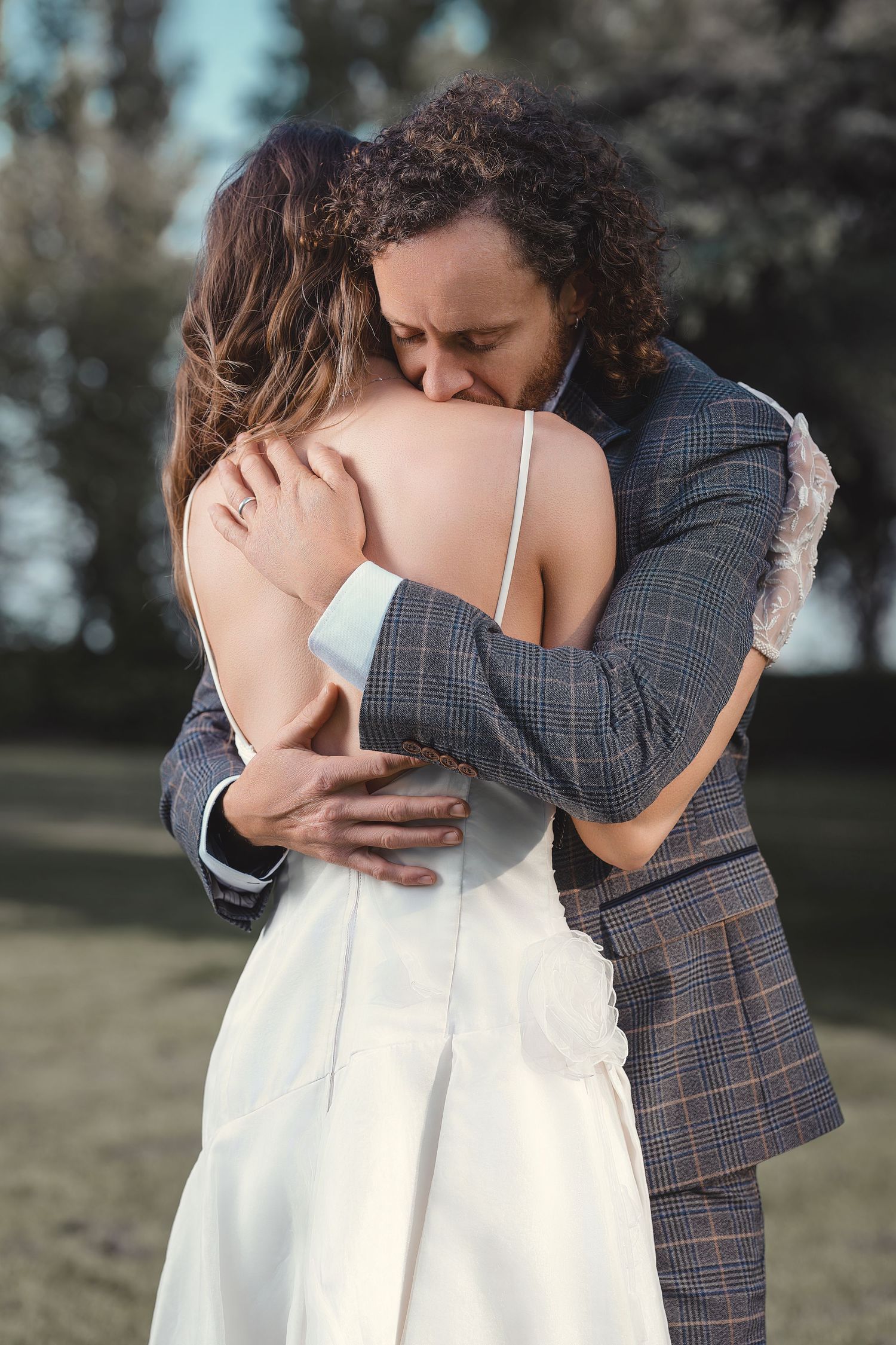 A couple embraces tenderly at Wick Farm, Bath, captured by Acet Photography.