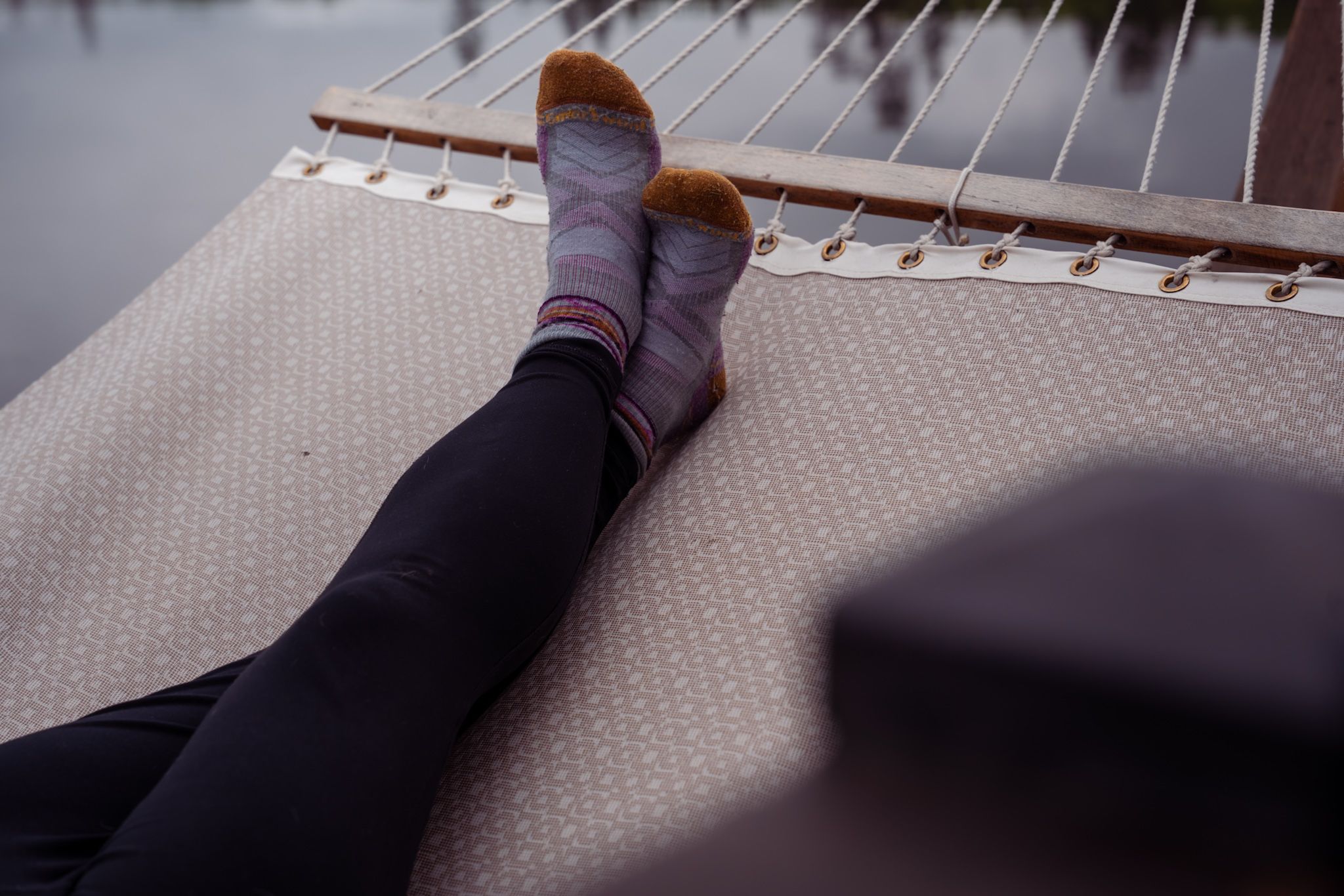 Sequence of close-up shots showing legs and feet resting on a gray carpet in different positions.