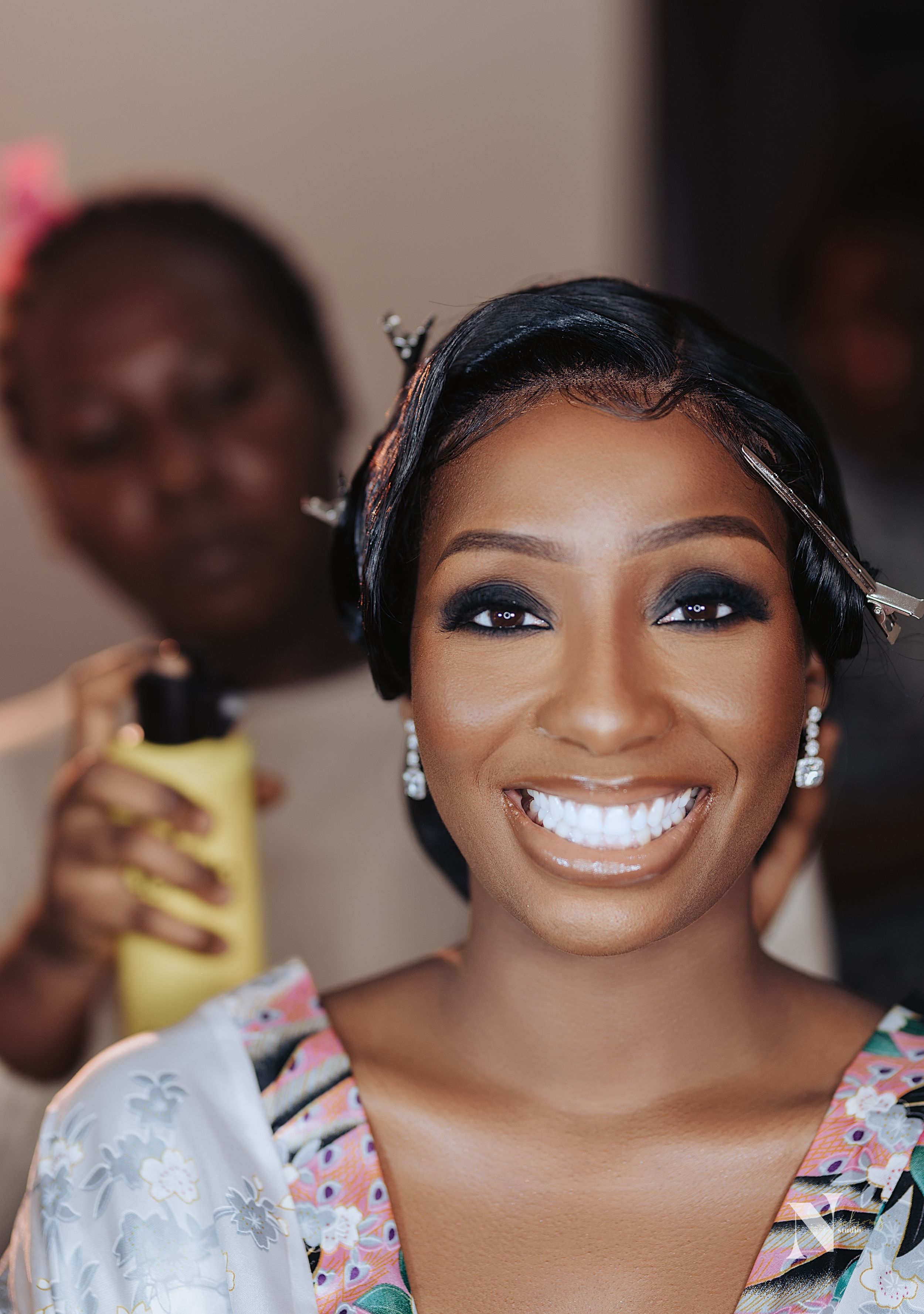 Radiant bride getting ready on her wedding day with beautiful makeup and earrings.