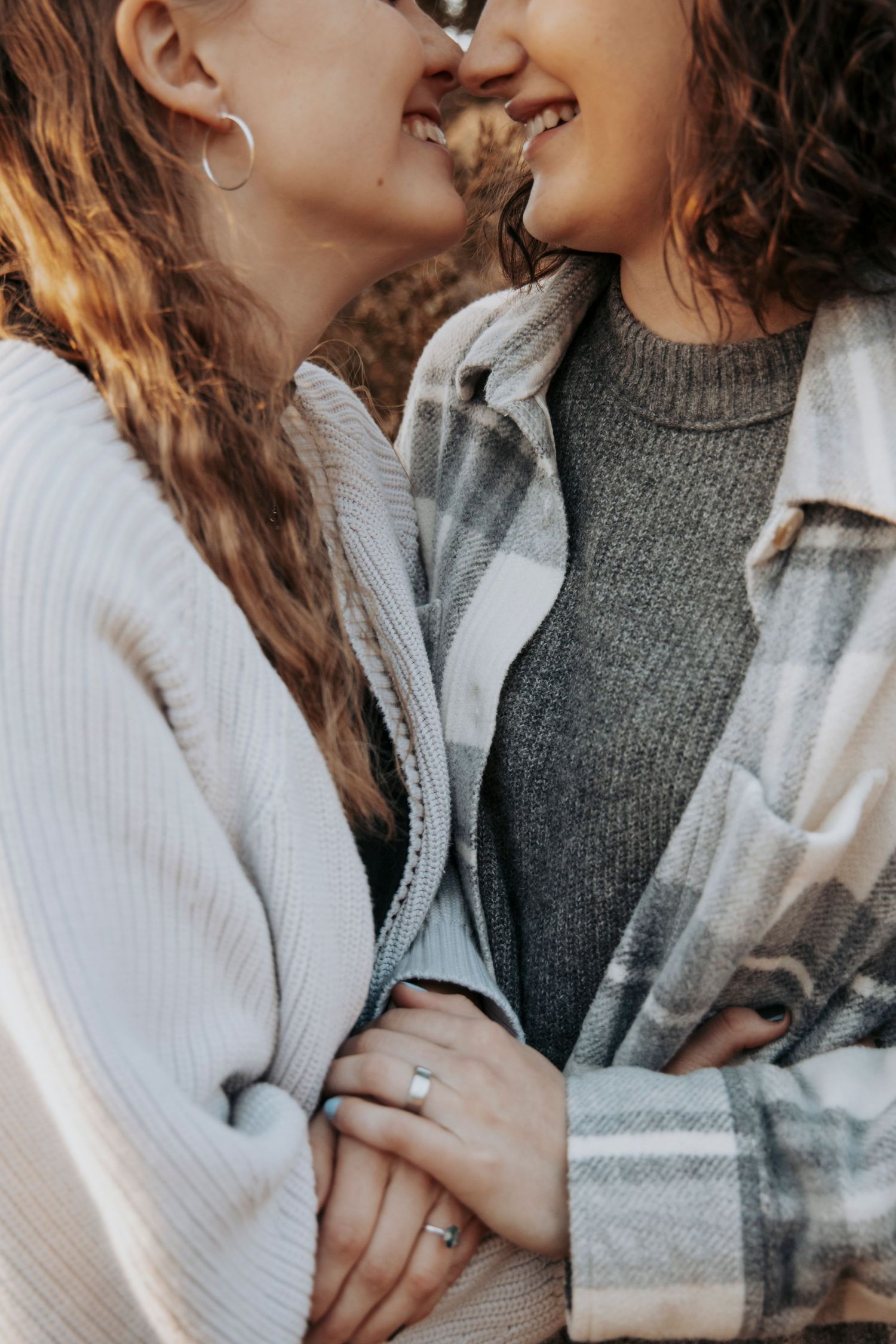 Close up of a tender romantic moment between two people wearing cozy sweaters.