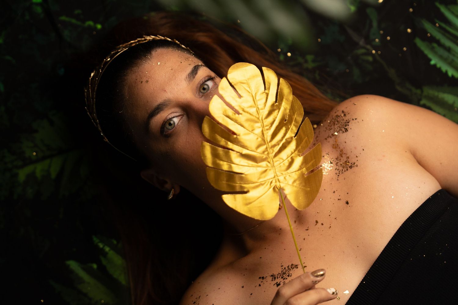 Glamour portrait featuring gold leaf accents and dramatic lighting.