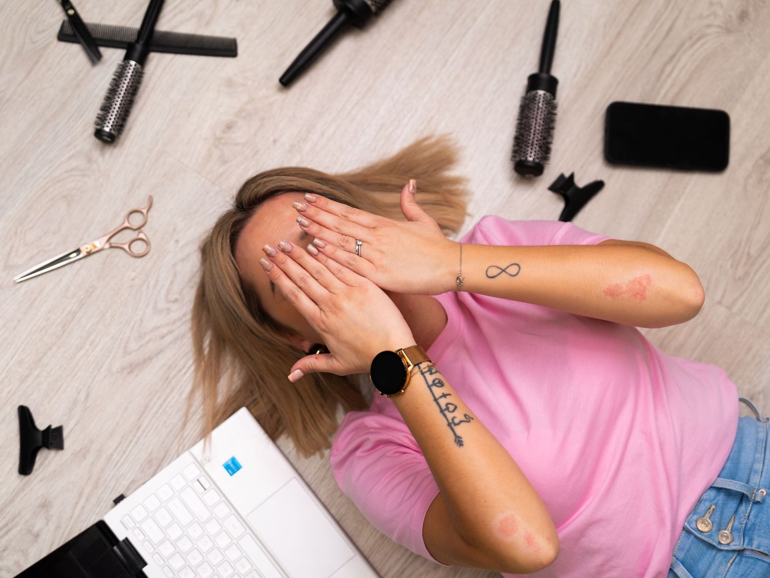 Beauty tools and accessories arranged on white surface in salon setting.