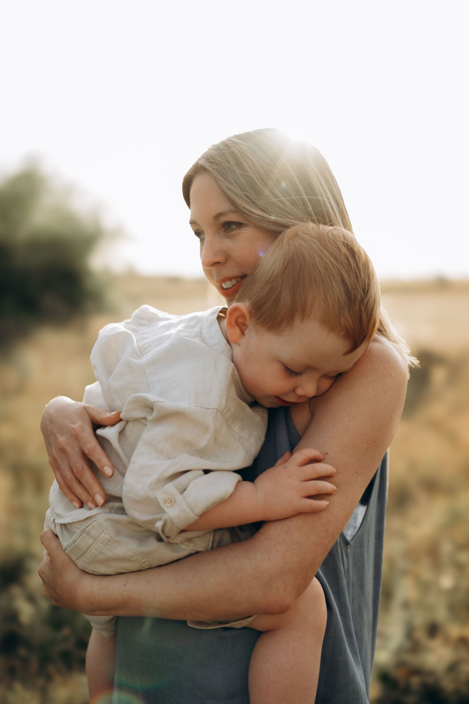 A little boy touching his mother's arm during their family photo session with Forever Ours Photography in Kent