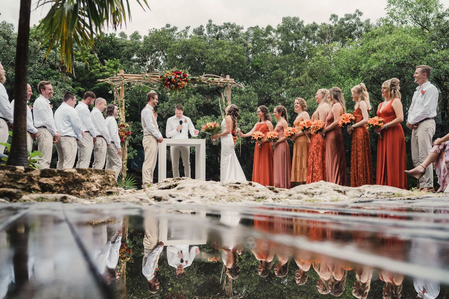 Wedding ceremony setup with rows of white chairs and palm trees along a scenic outdoor venue, Sandos Caracol Wedding.
