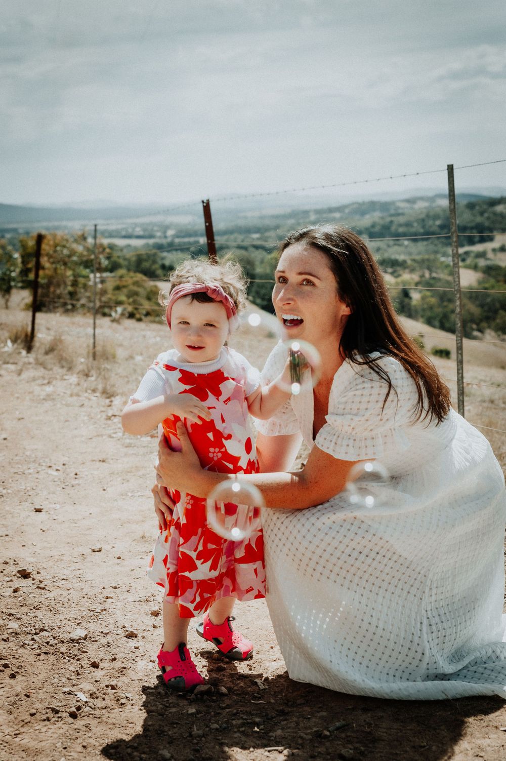 Mother and children having fun during outdoor photoshoot on hillside.
Altona Family Photographer Melbourne