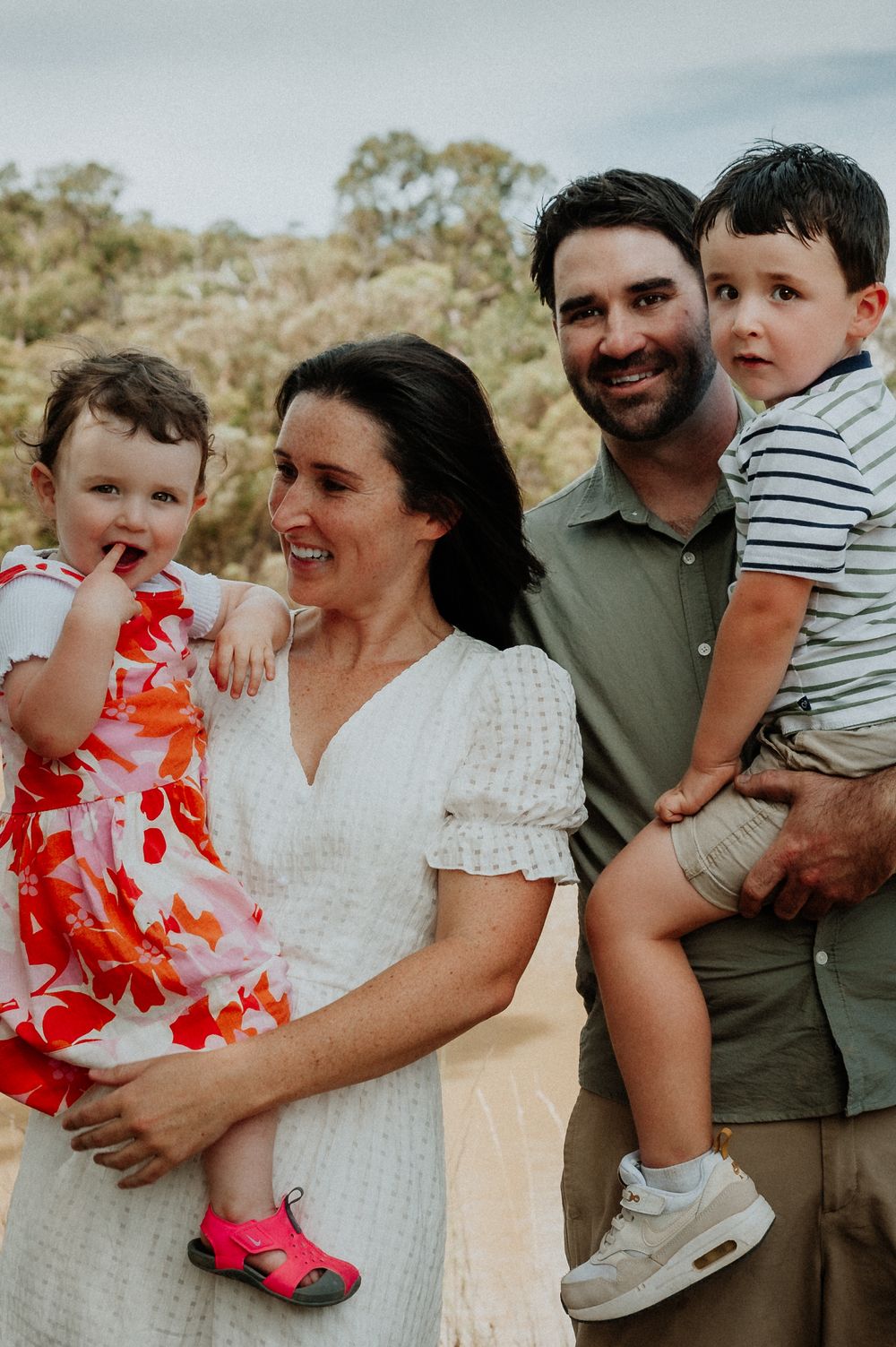 Family enjoying a casual outdoor photoshoot together wearing coordinated outfits in a natural setting.
Altona Family Photographer Melbourne
