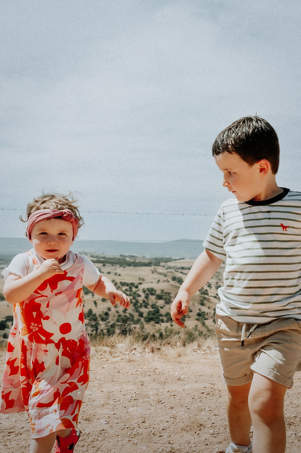 Children playing and running together on dusty hill path.
Altona Family Photographer Melbourne