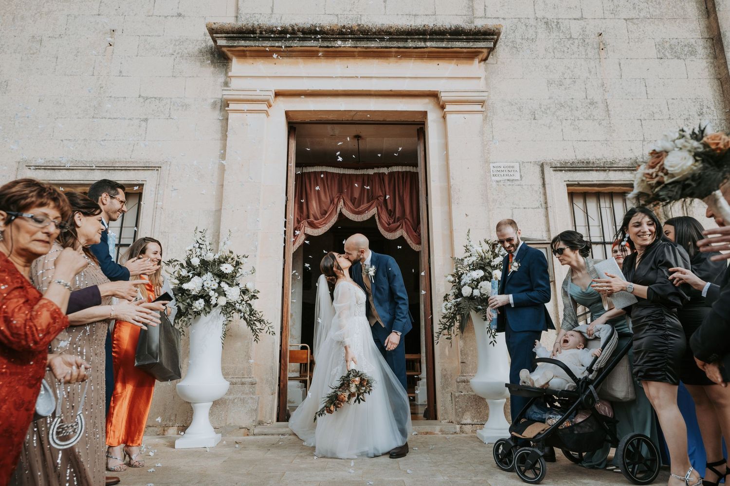 Wedding party celebrates with champagne toasts in elegant venue during reception festivities.
