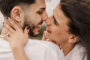 Couple embracing and laughing together in close-up shots during golden hour.