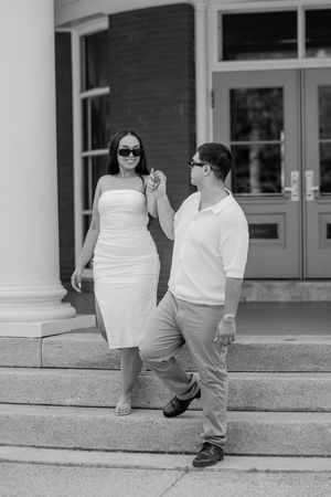 A sequence of black and white photos showing someone in white clothing sitting on concrete steps outside a building.