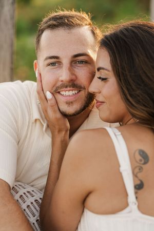 A romantic couple shares intimate moments in a series of outdoor portrait photos with natural lighting.