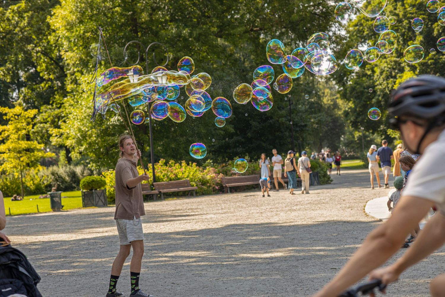a man launches colorful balloons in the park in the evening. Bernardinų Vilnius park