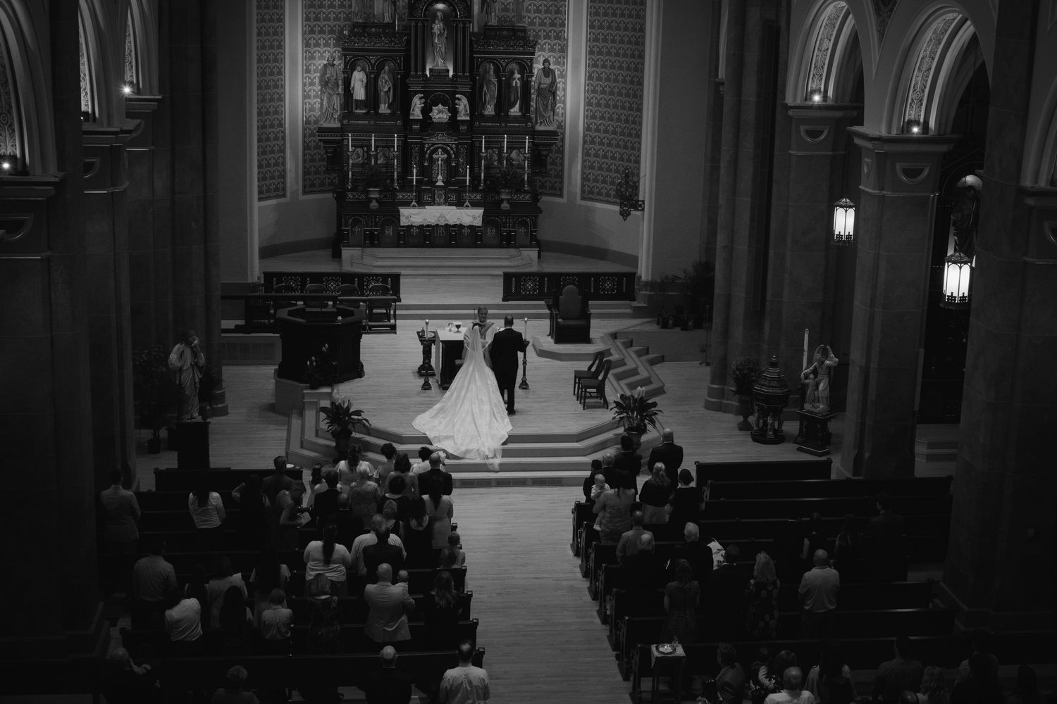 Black and white photo of a couple at the altar at a beautiful church in St. Paul Minnesota