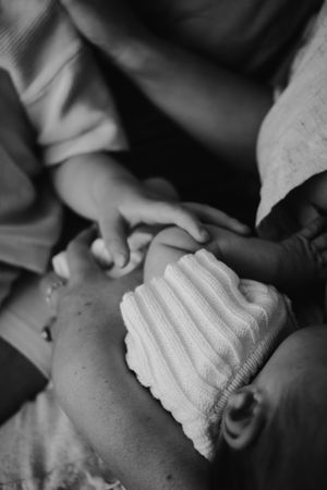 Close up of toddler touching his baby sister.