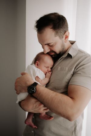 Newborn baby being held on dad's chest.