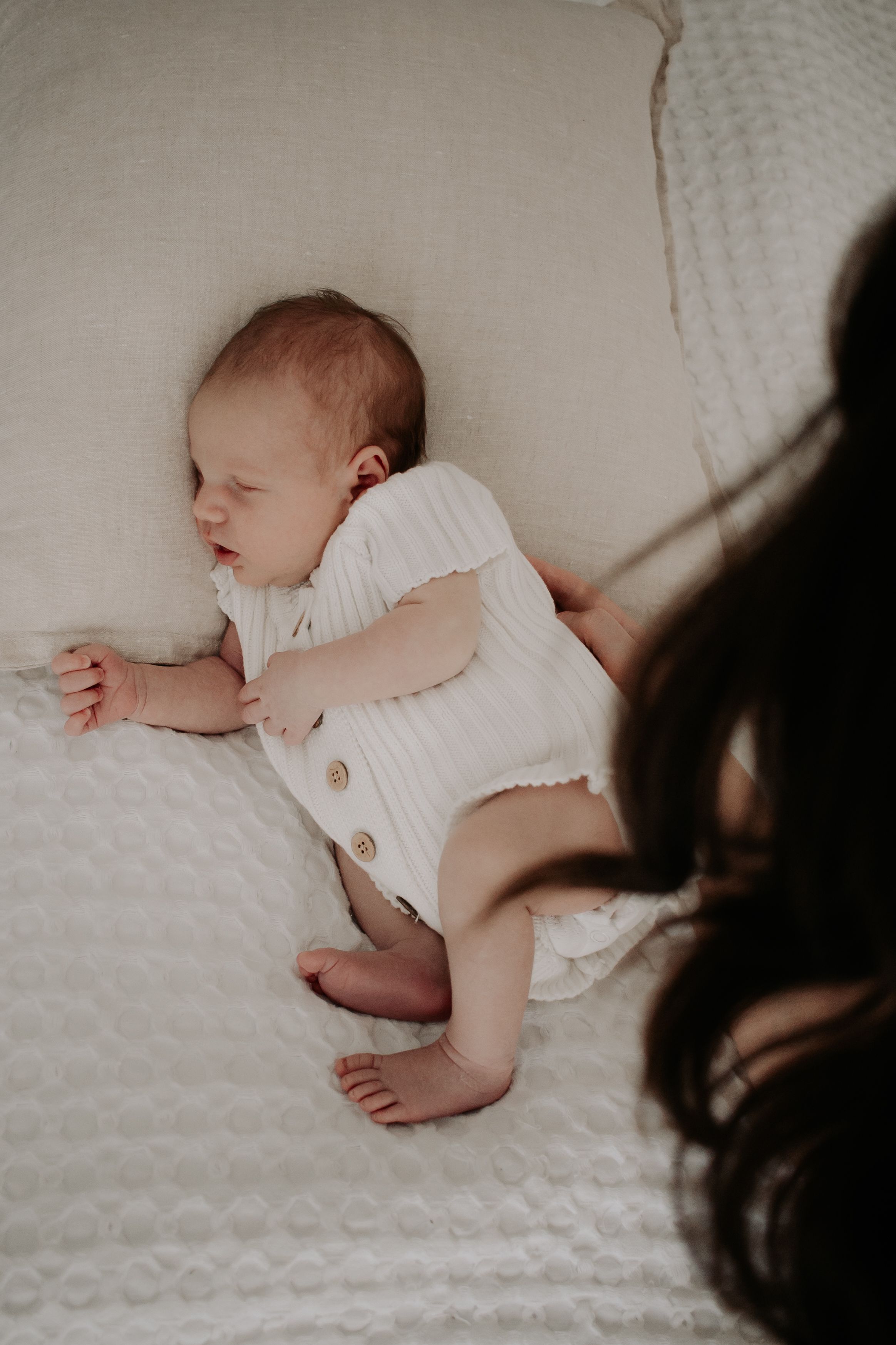 Newborn baby being caressed by mum.