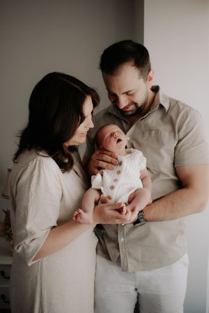 Mum and dad holding newborn.