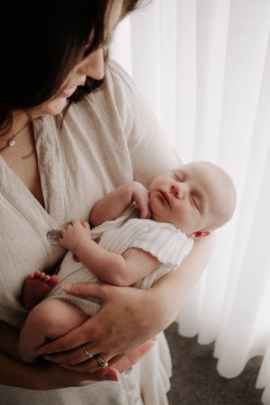 Baby sleeping in mum's arms.