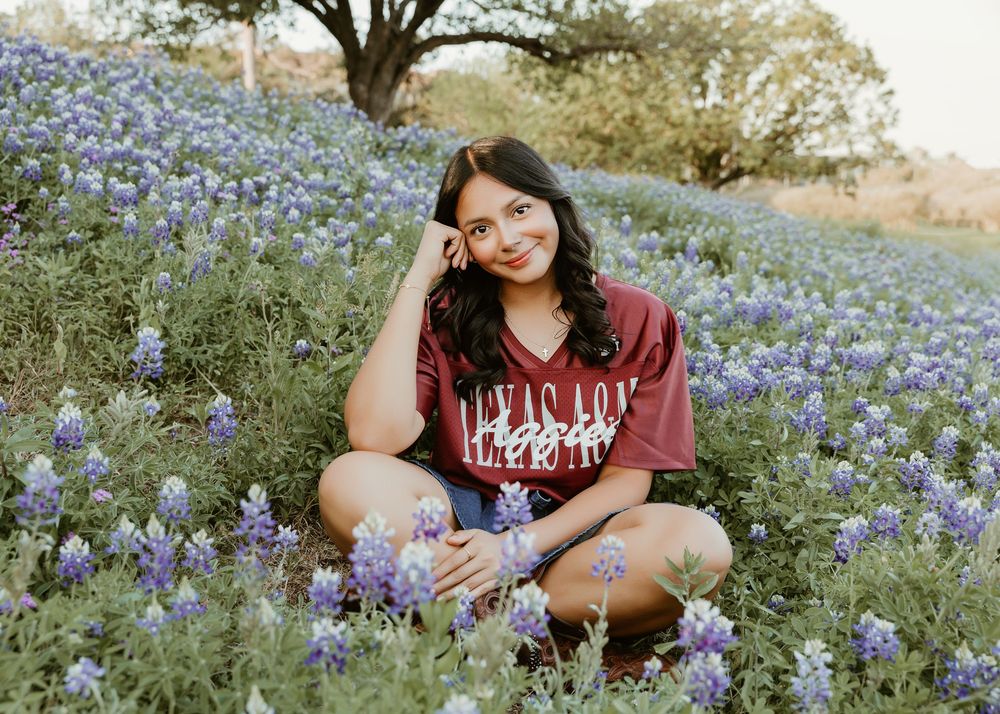 Houston senior photographer capturing modern high school senior portraits with bluebonnets
