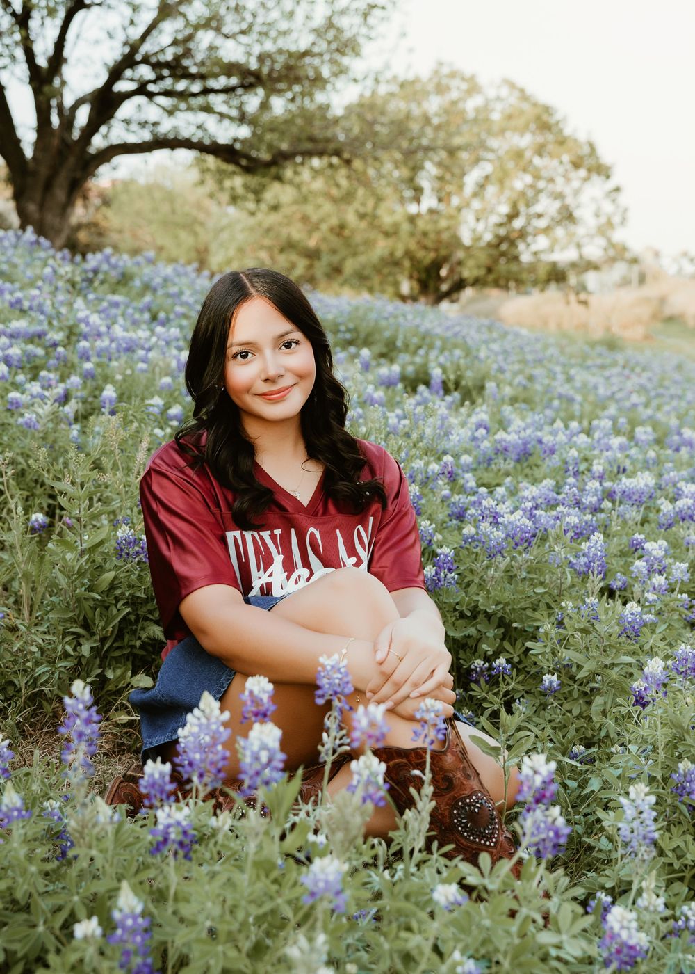 Houston senior photographer capturing modern high school senior portraits with bluebonnets