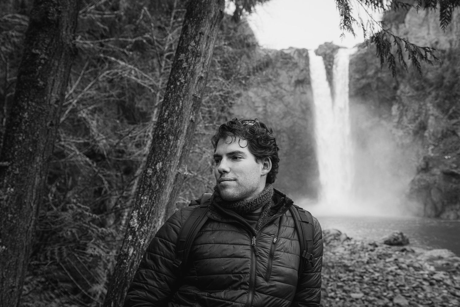 A portrait of Andrey Boltyansky, owner of Swanky Bolt Studios, while travelling with waterfalls and mountains in the background.