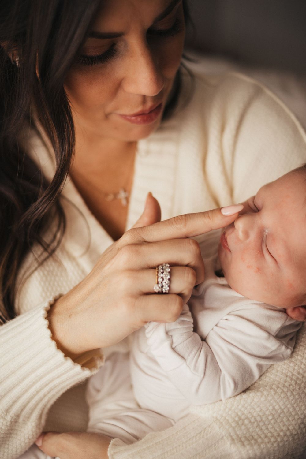An intimate close-up of a tender moment with a sleeping newborn.