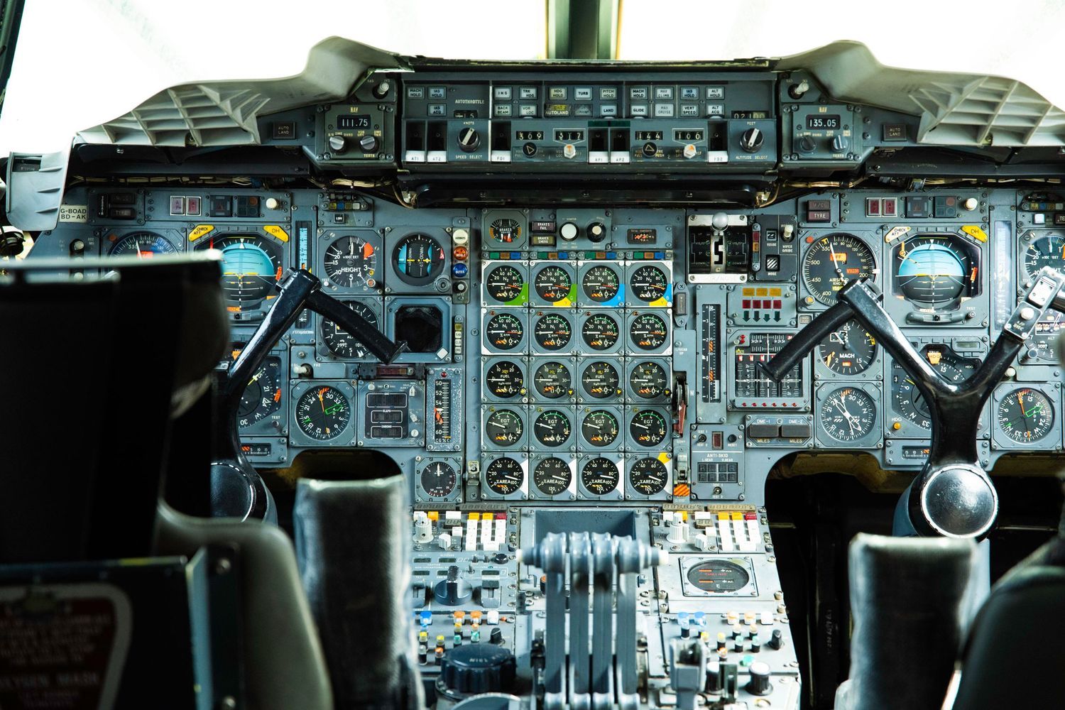 Complex instrument panel and controls in a vintage military aircraft cockpit.