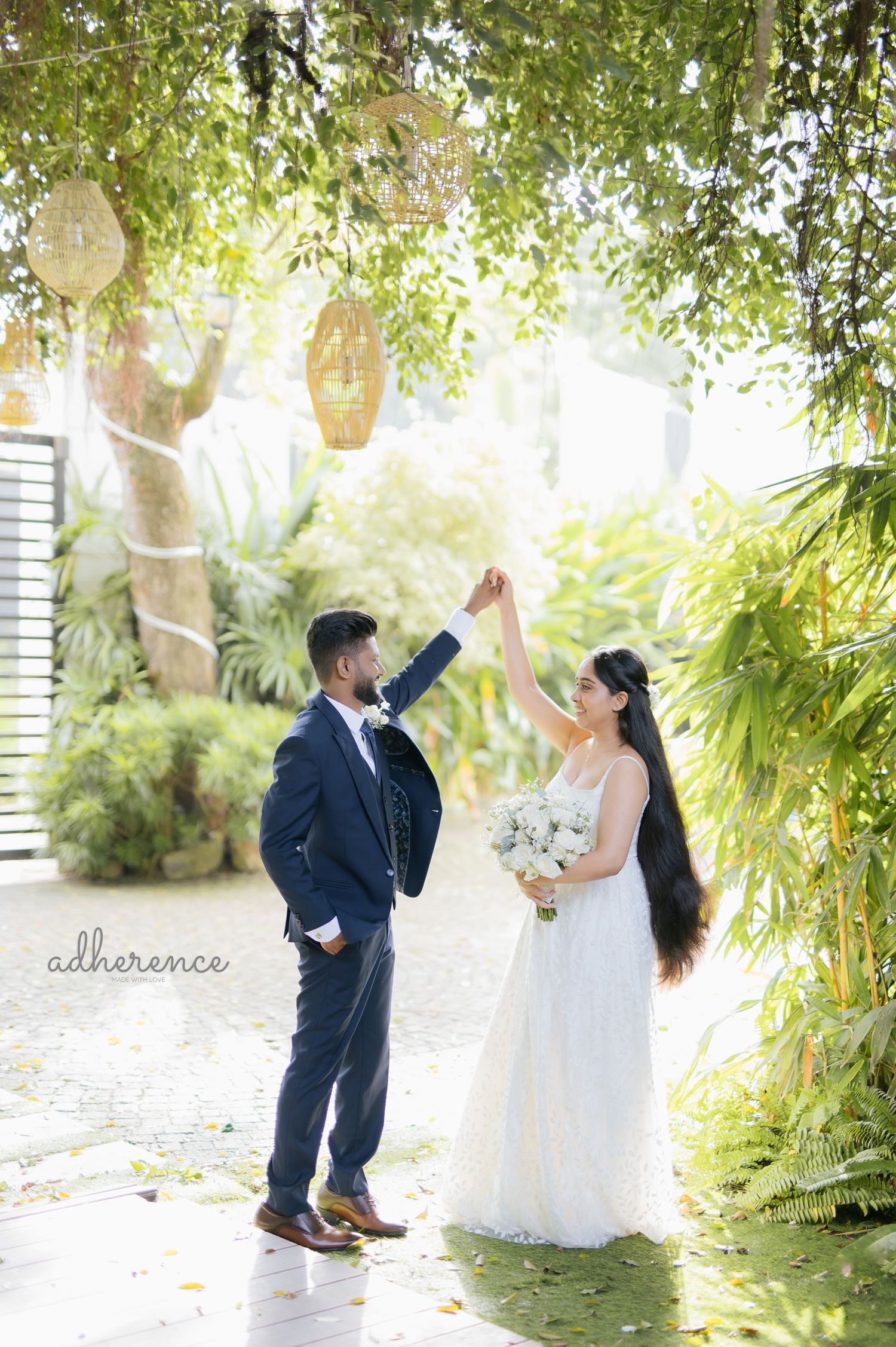A romantic outdoor wedding photo with lanterns and lush greenery creating a magical garden atmosphere.
