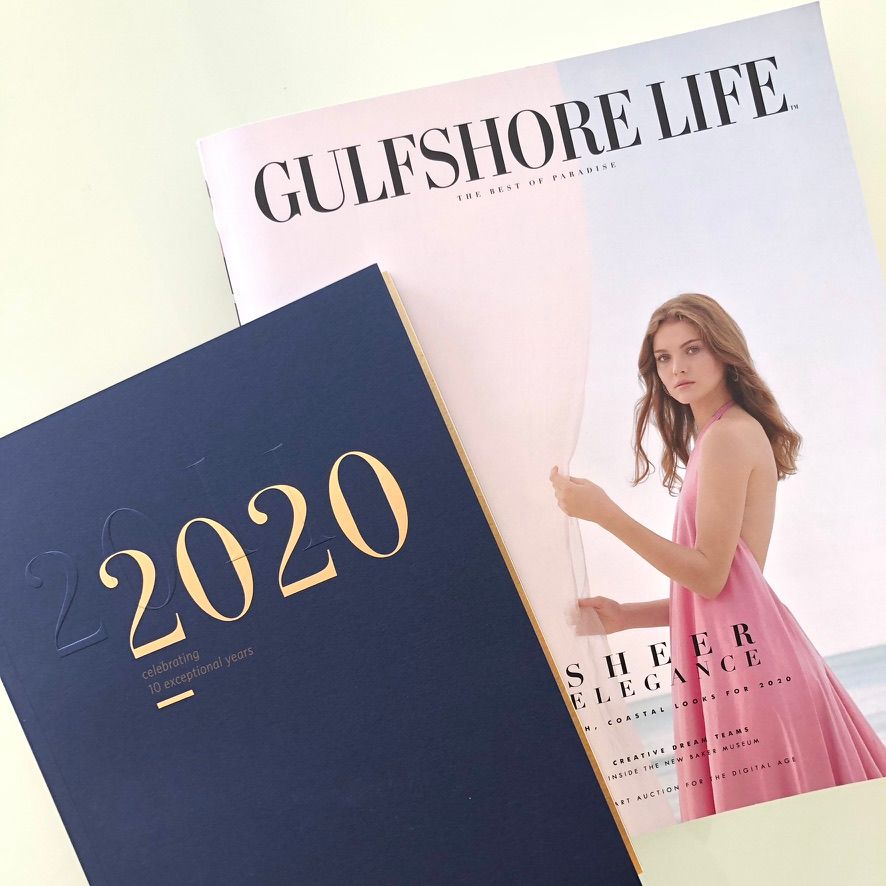 Gulfshore Life magazine 2020 issue featuring a woman in a pink dress on the cover, alongside a navy 2020 planner.