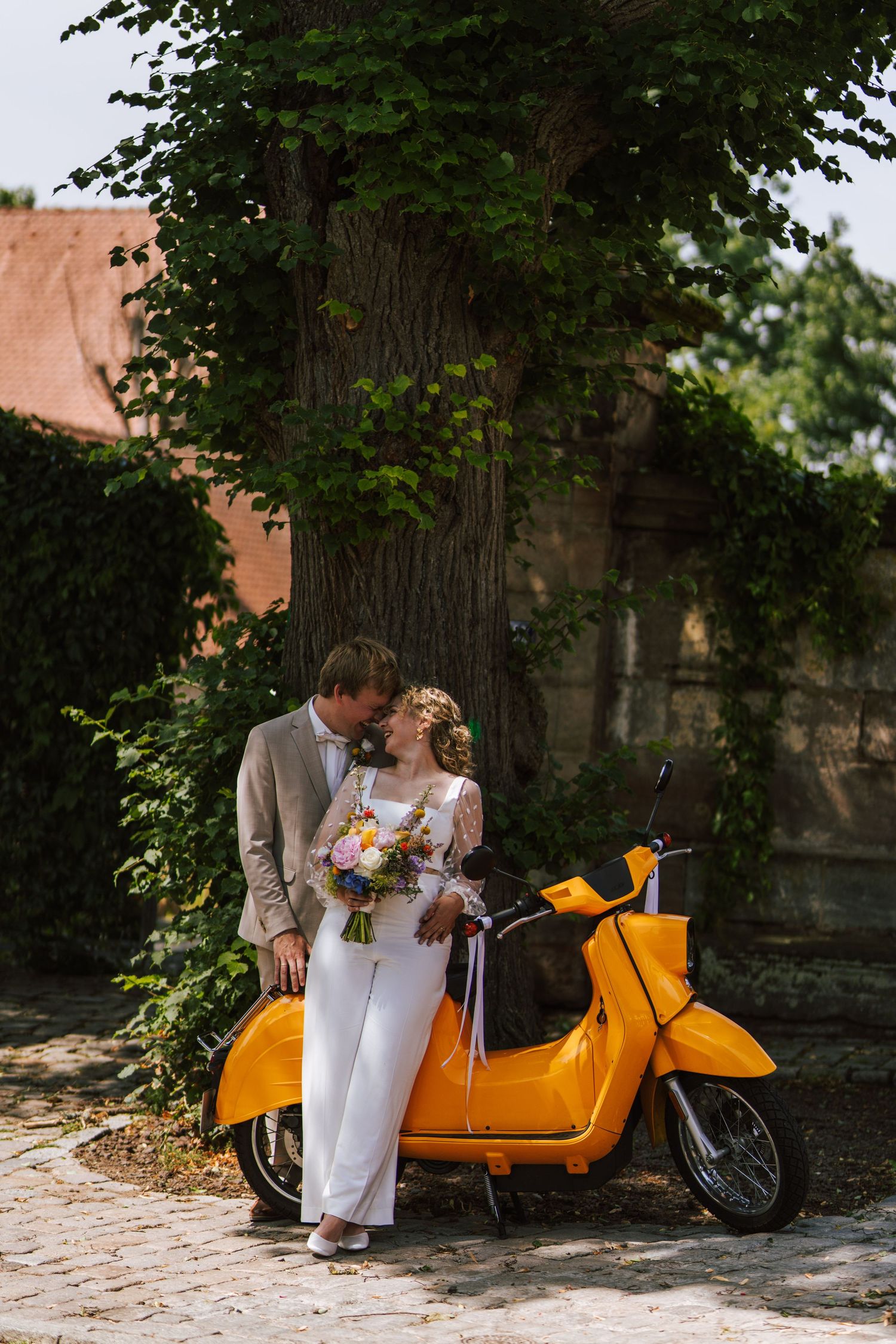 Intimate wedding portrait shows tender moment through delicate veil details.