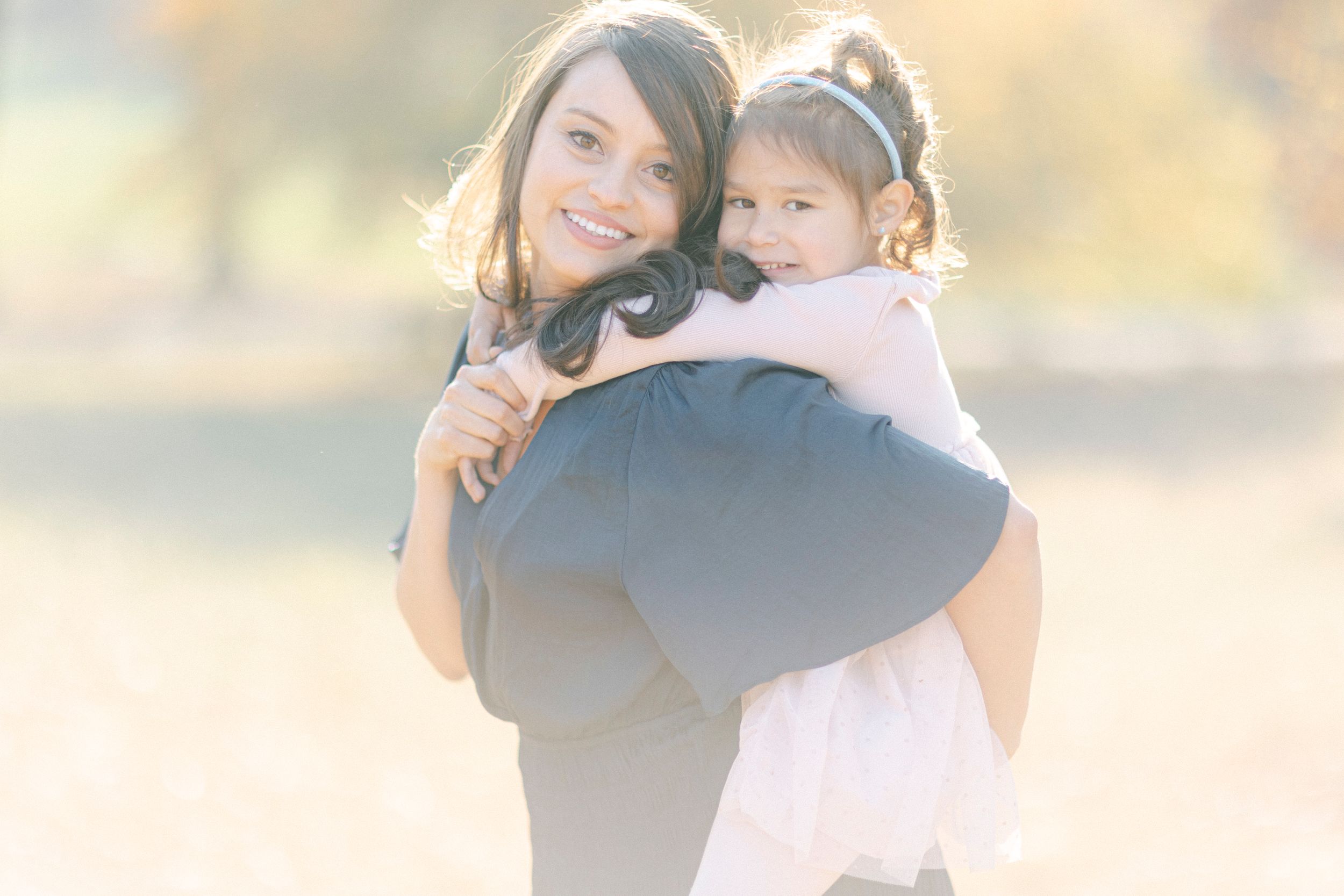 A sweet bonding moment between two figures captured in soft natural lighting.