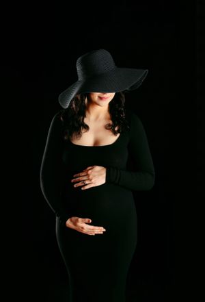 Dramatic silhouette maternity photos in black against dark background. Middle TN maternity and newborn photographer.