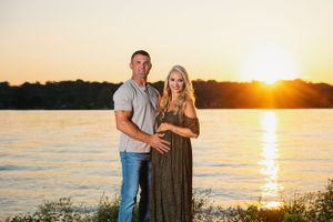 Romantic sunset maternity photos of couple at waterfront location. Middle TN maternity photographer.