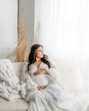 Dreamy maternity photos in a white lace dress against a bright window setting. Middle TN Maternity Photographer