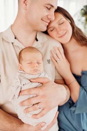 mom dad and baby boy during newborn session