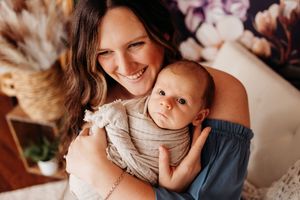 mommy and baby laughing at silly baby's face during newborn session