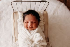 little baby smiles during newborn session