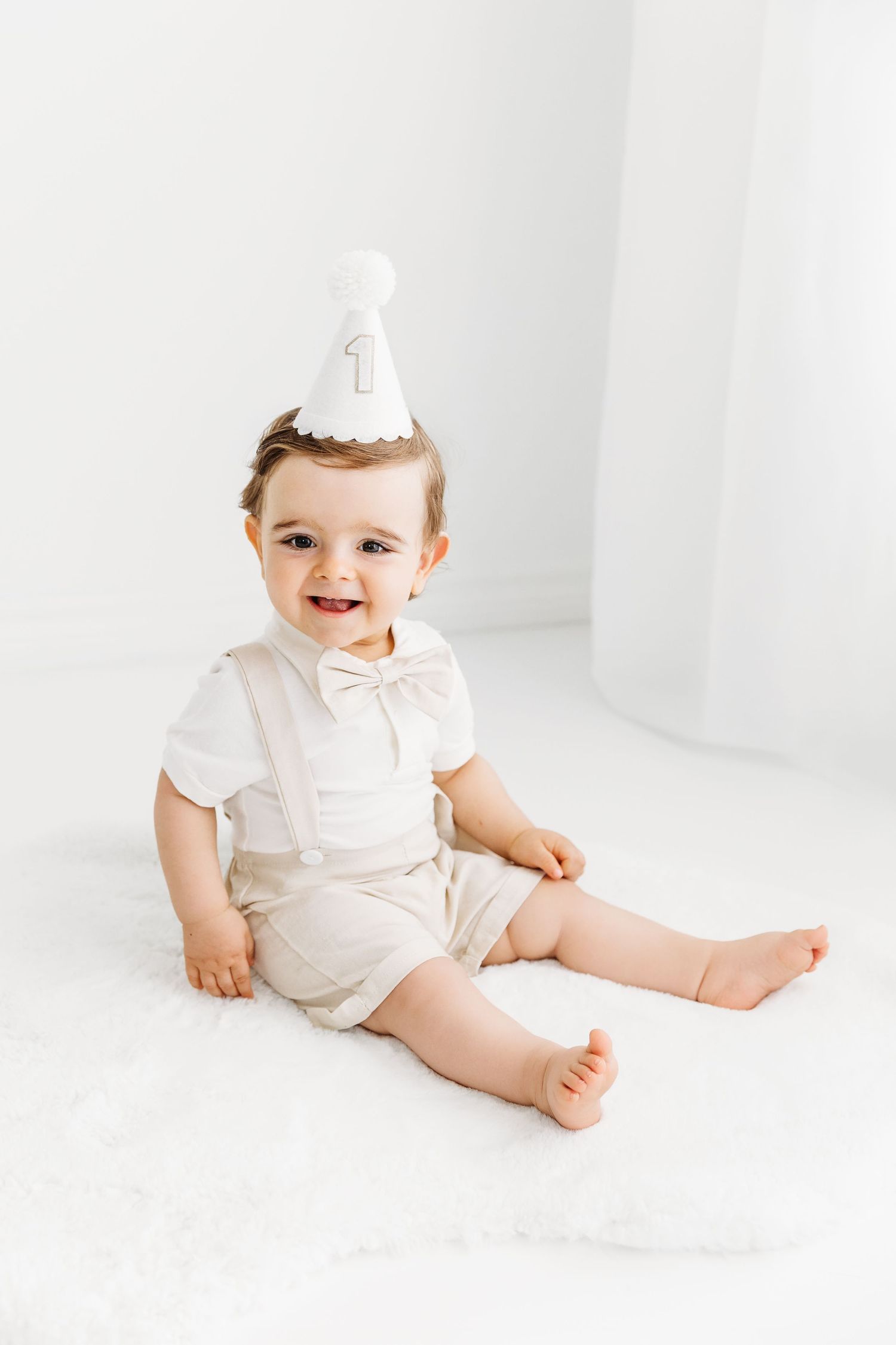 1 Year Old wearing birthday hat, birthday portraits in a white studio
