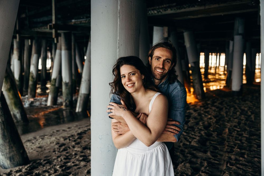Couple shares intimate moments during their wedding celebration at sunset.