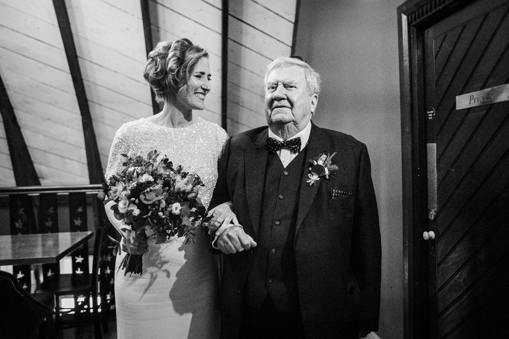 Black and white wedding photo moment with elegant bouquet.